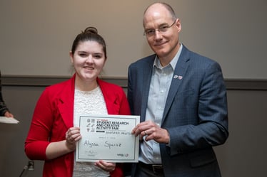 Photo of Alyssa Spartz receiving an award.