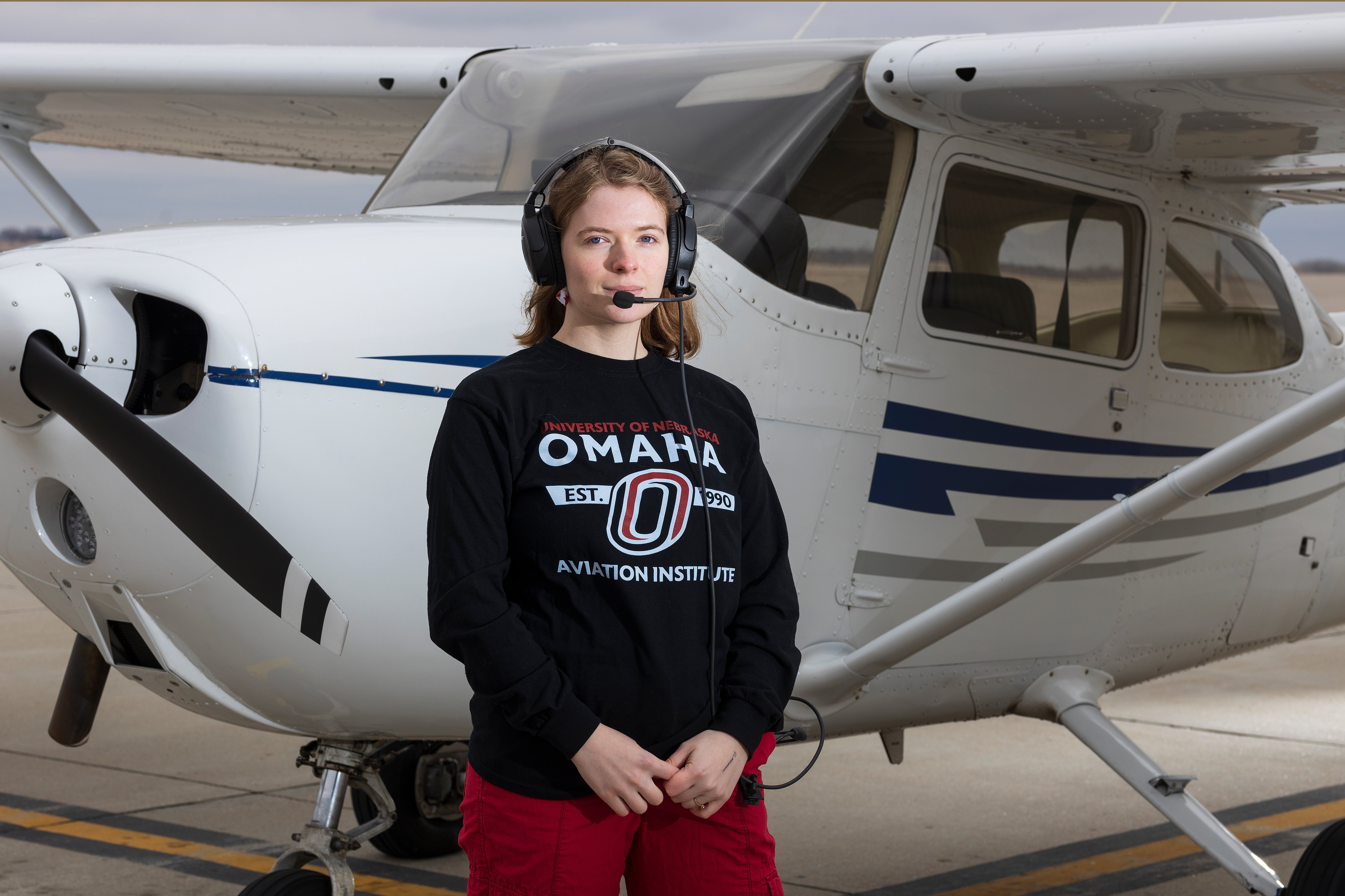 Photo of Gwendoline Dunlop in front of an airplane.