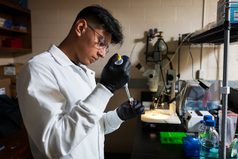 Photo of Brandon Villanueva-Sanchez working in a laboratory..