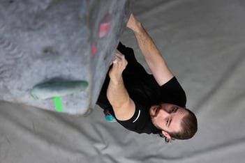 Joseph Wiese climbing rock wall in wellness center
