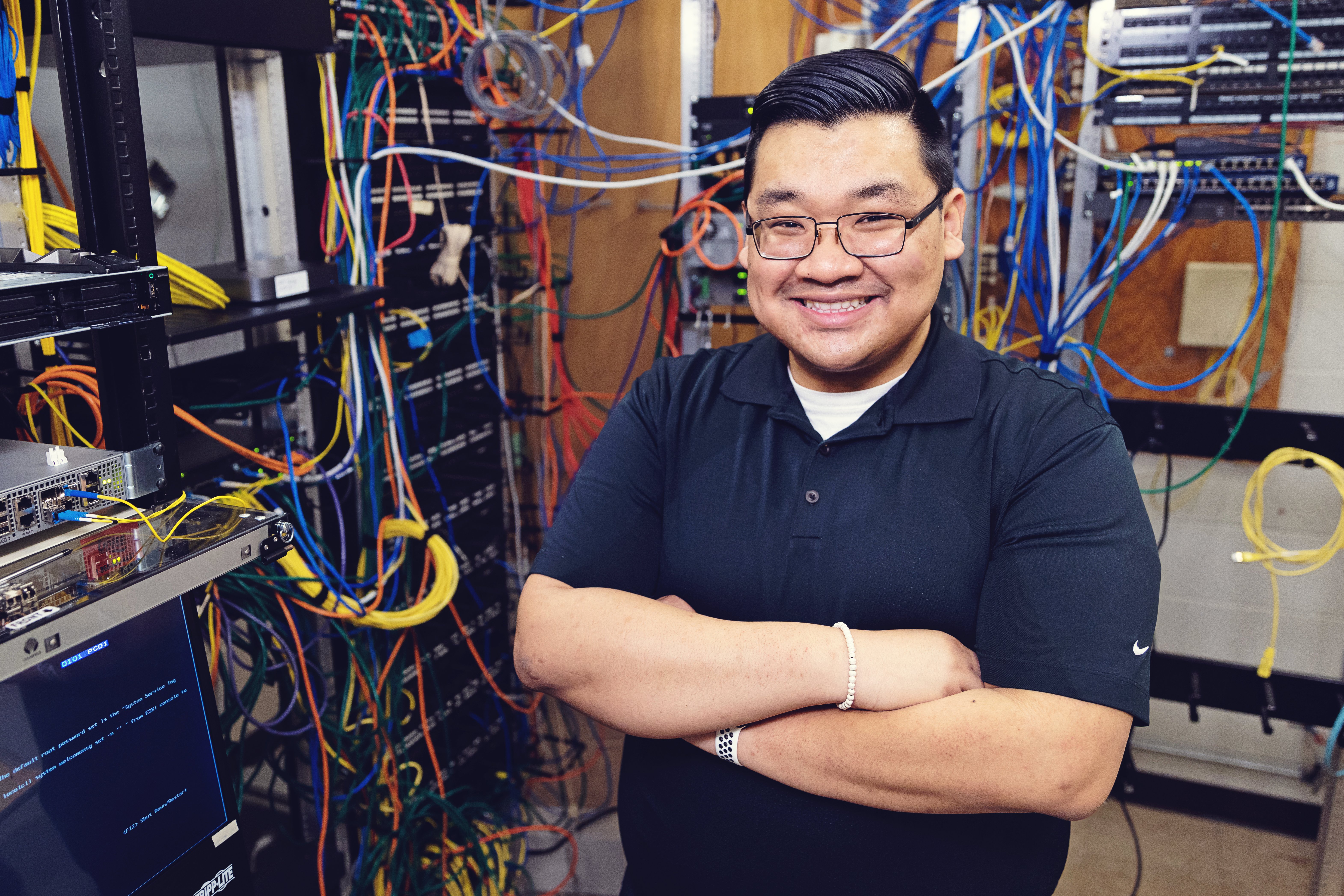 Travis Vo poses in a data storage room.
