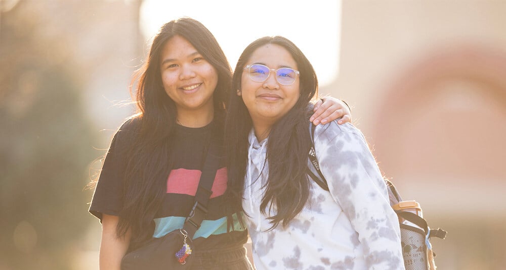 Mary and Mayjem Palafox smile together on campus. 